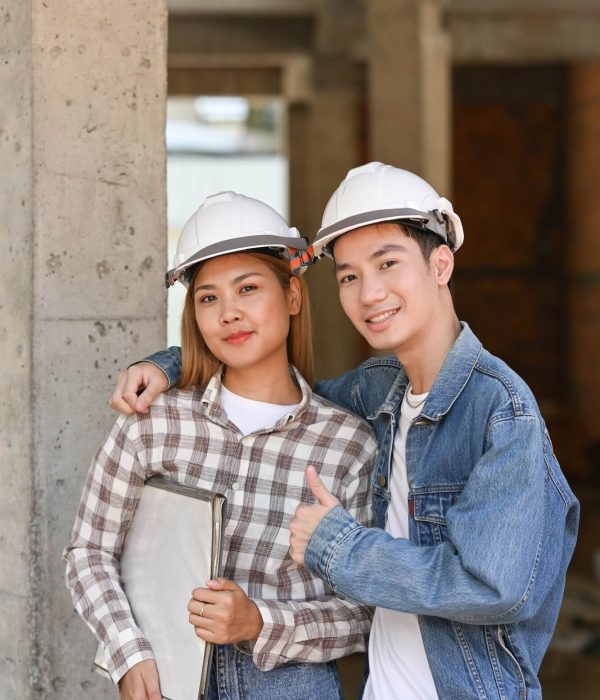 two-happy-investors-in-helmet-standing-at-construction-site-real-estate-investors-concept-