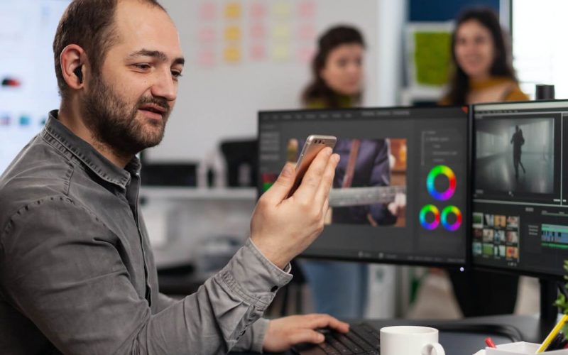 video-editor-discussing-online-with-customer-designer-holding-smartphone