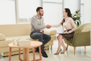 female psychiatrist and patient shaking hands in office