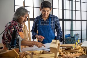 Two carpenters making DIY craft wood product and construction material furniture of carpentry