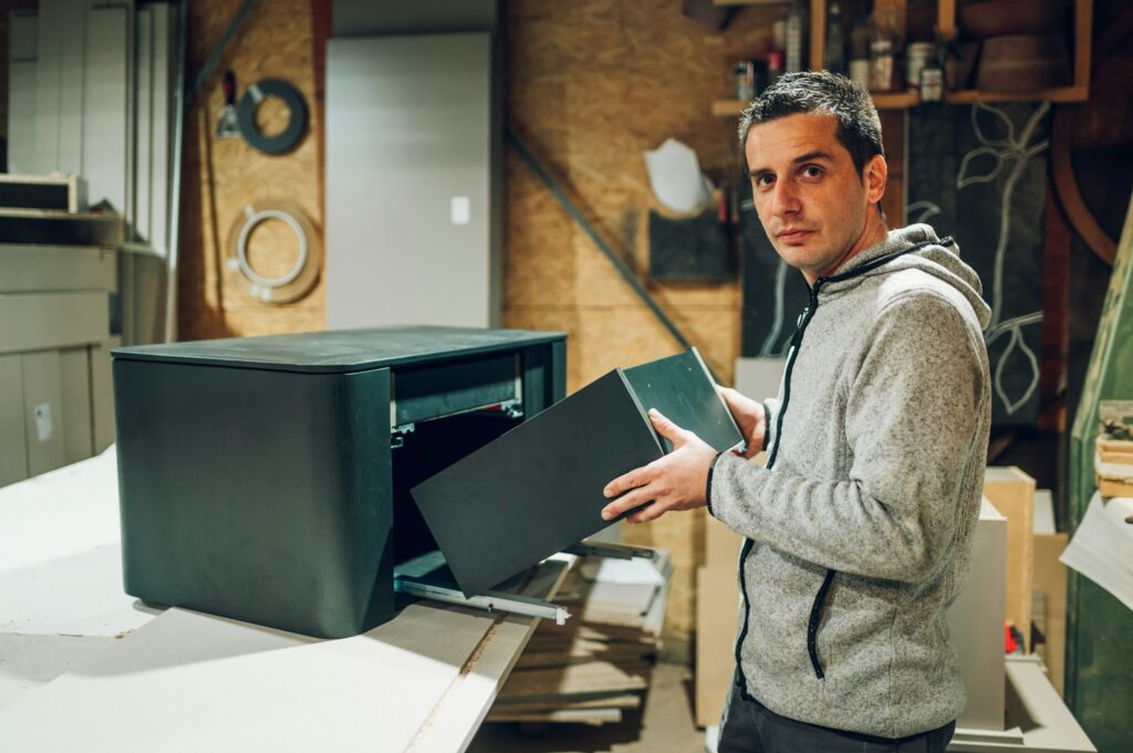 A carpenter is joining furniture in his workshop.