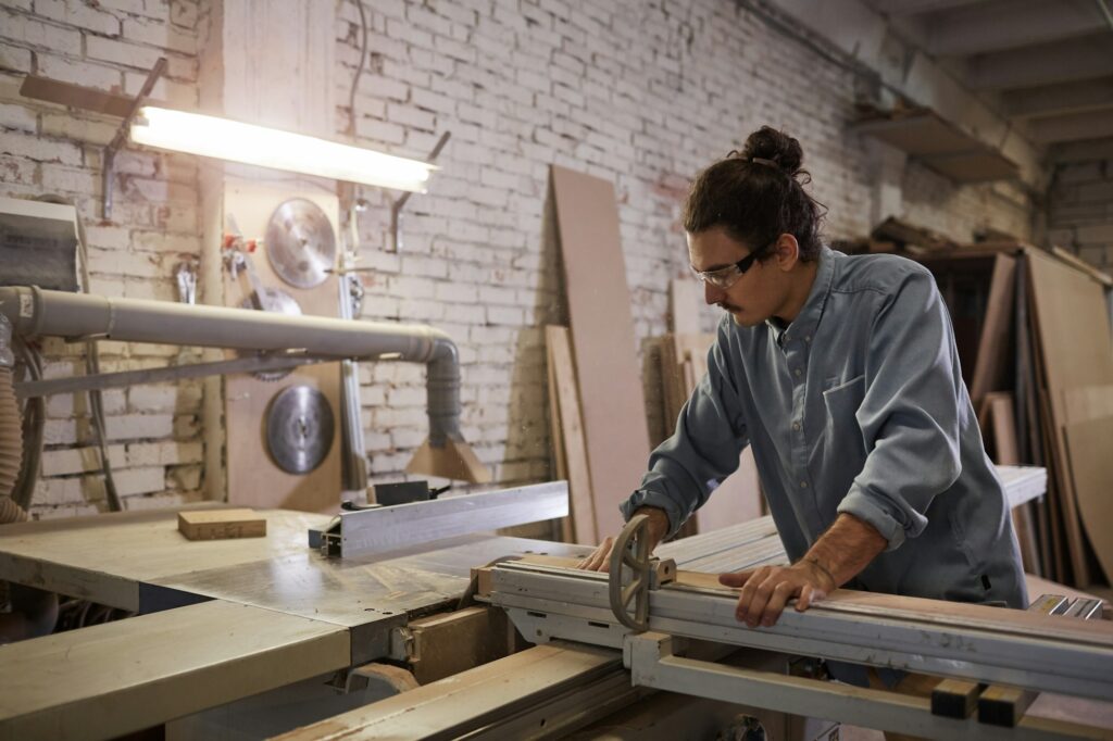 Carpenter making furniture in workshop