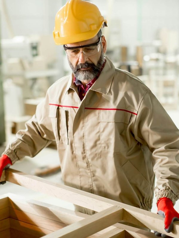 Middle aged worker working in the furniture factory
