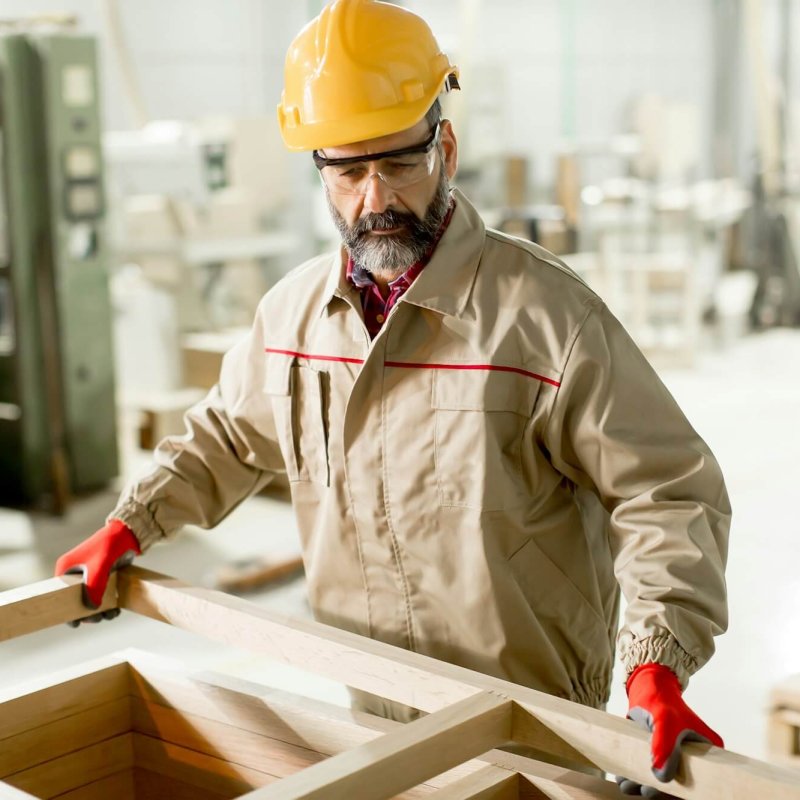 Middle aged worker working in the furniture factory
