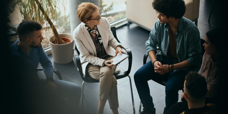 Above view of counseling during group therapy at mental health center.