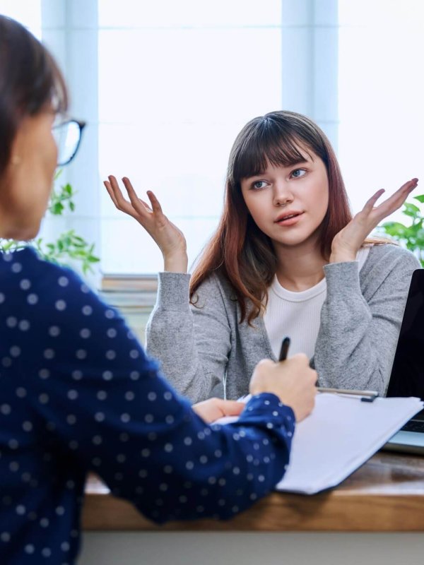Teenage girl at therapy session with mental health professional