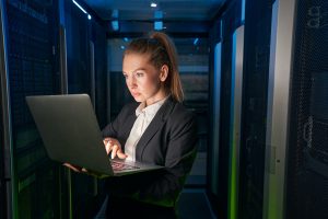 Young attractive woman working in server room